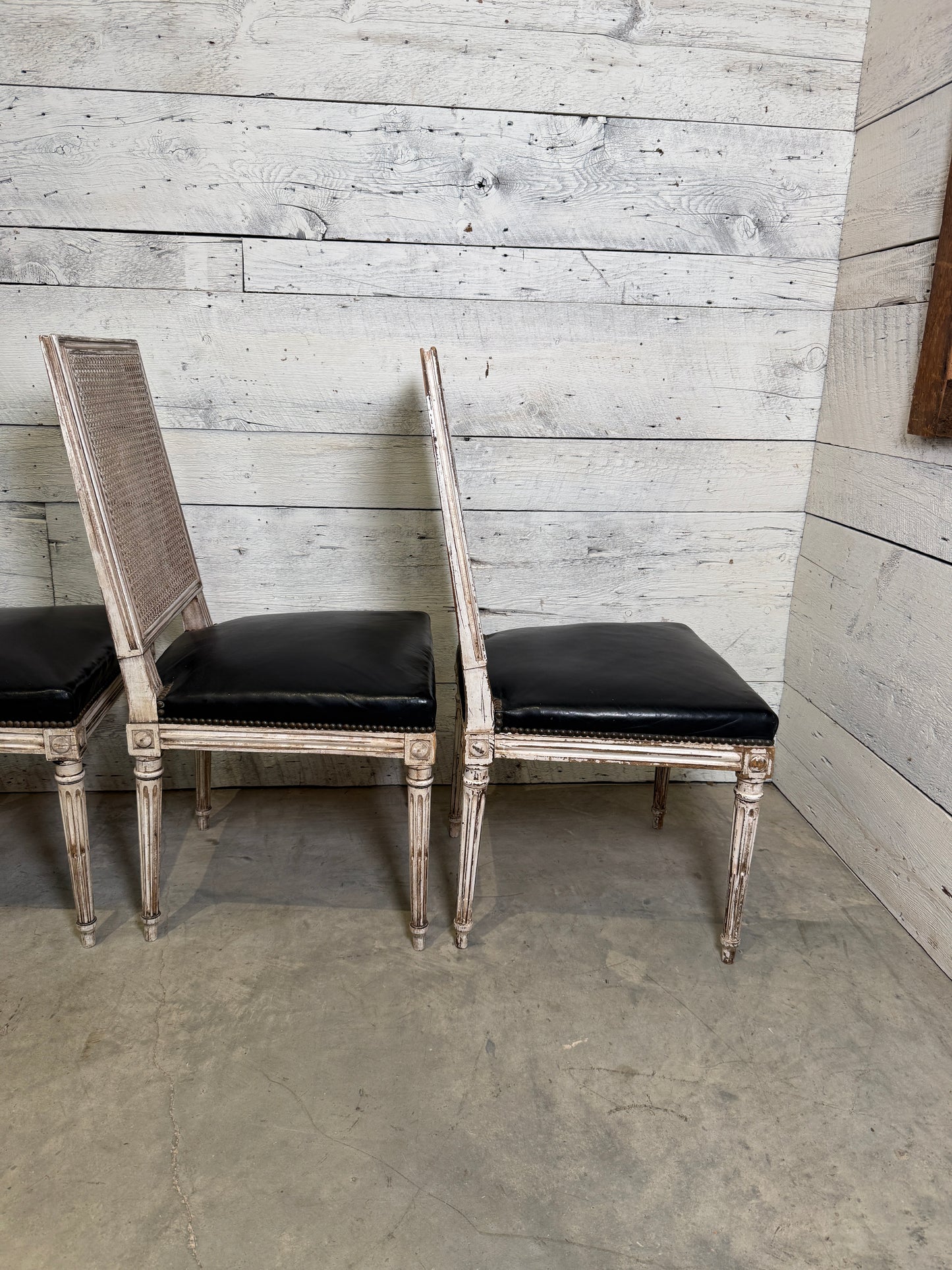 Set of Black Leather and Cane Back Dining Chairs in the Colonial Style