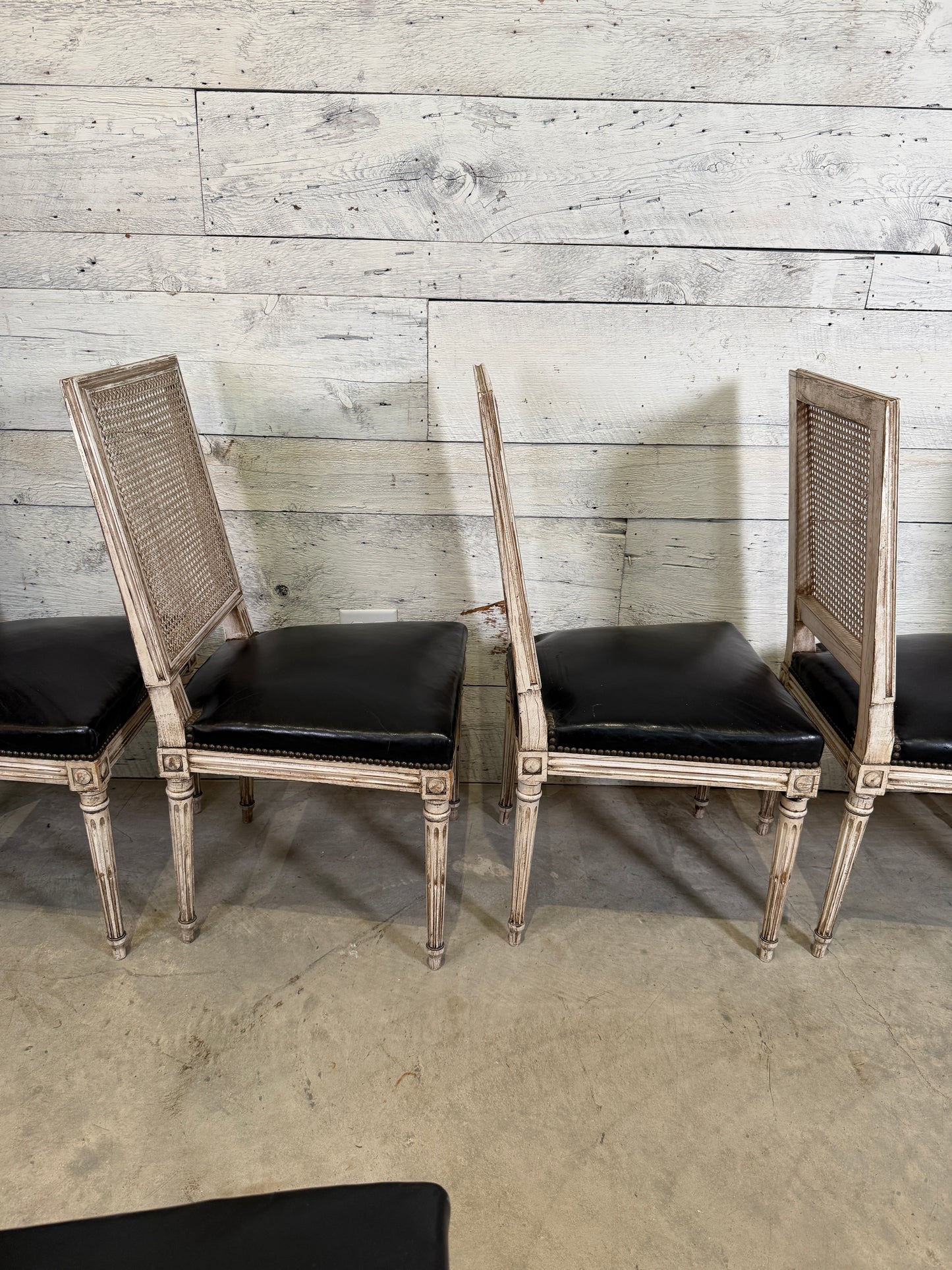 Set of Black Leather and Cane Back Dining Chairs in the Colonial Style