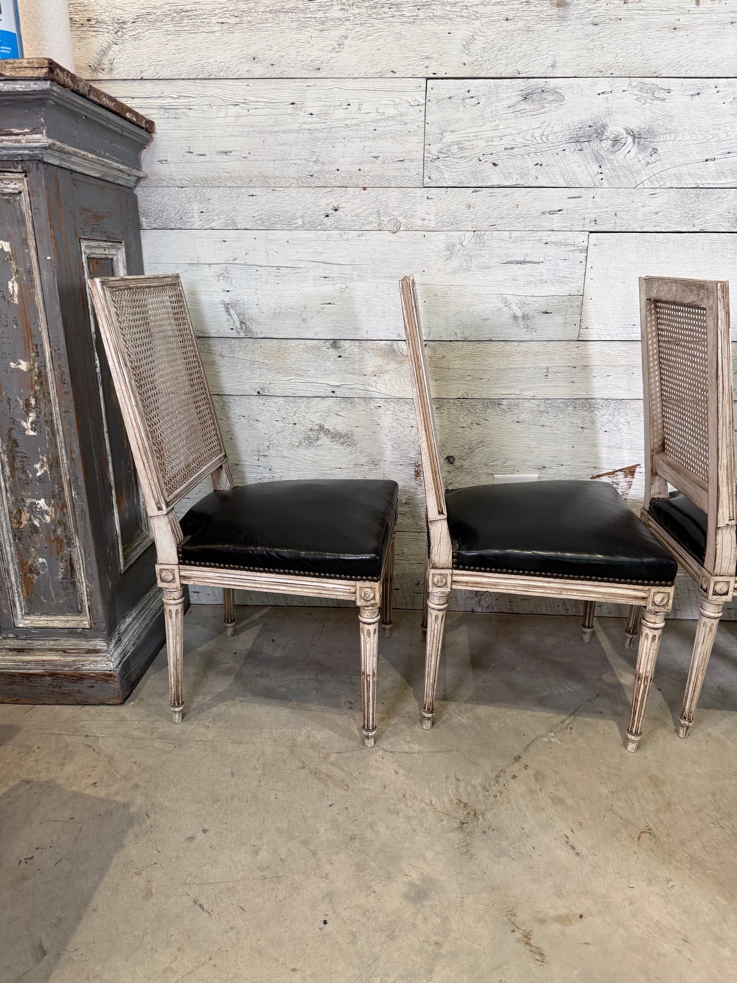 Set of Black Leather and Cane Back Dining Chairs in the Colonial Style
