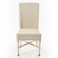Wicker chair on a concrete floor with a cluttered background