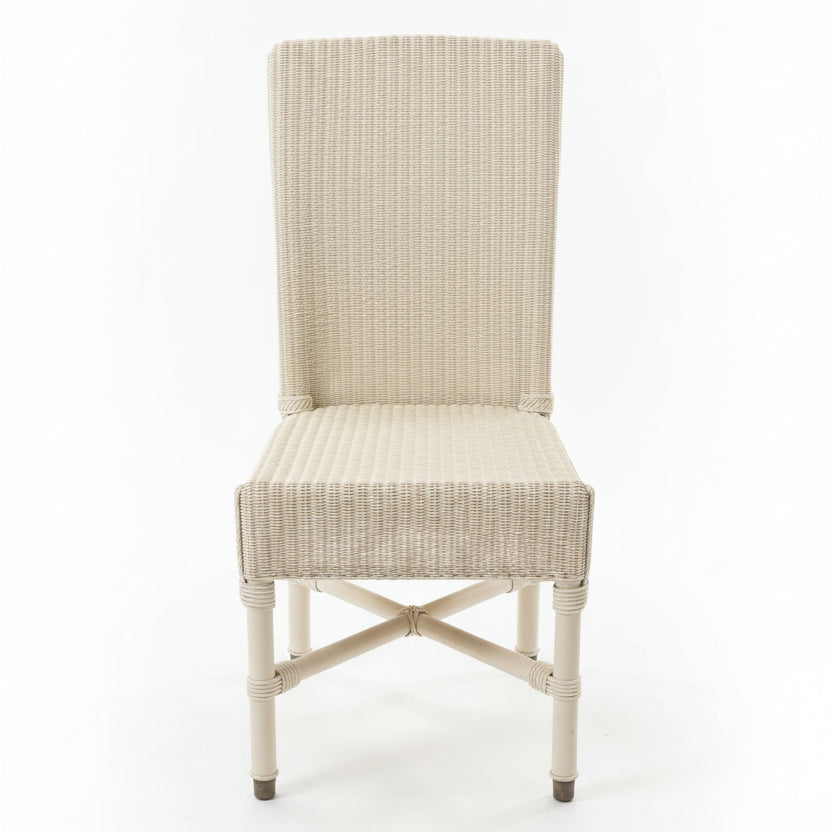 Wicker chair on a concrete floor with a cluttered background