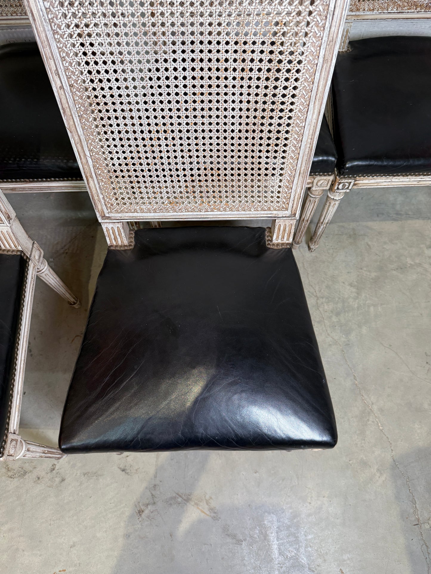Set of Black Leather and Cane Back Dining Chairs in the Colonial Style