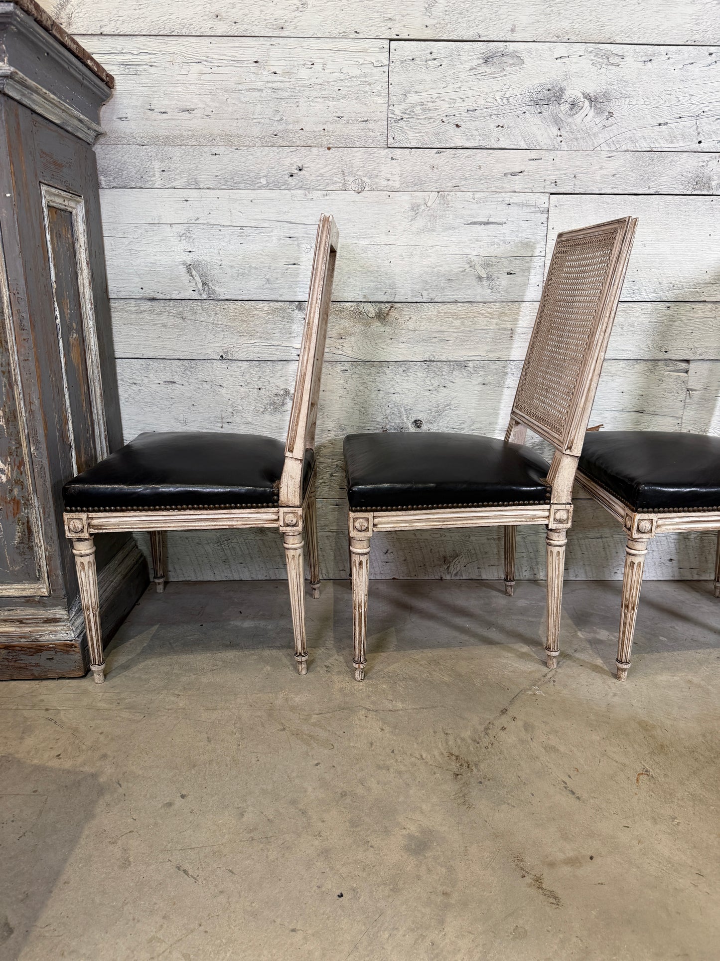 Set of Black Leather and Cane Back Dining Chairs in the Colonial Style