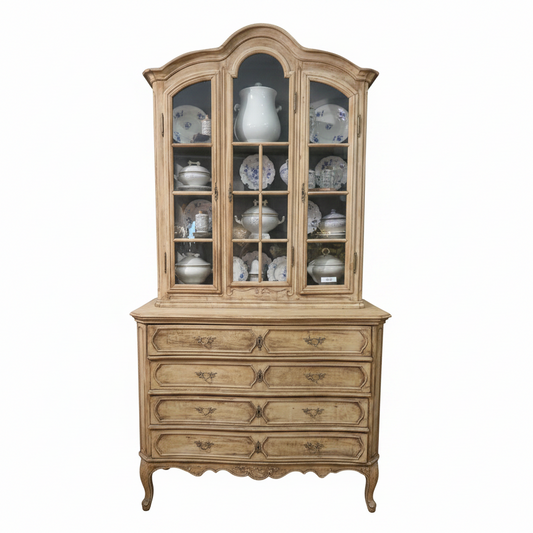 An antique 19th Century French hutch with glass doors and brass handles. The furniture is beige with a blue interior visible through the glass doors.