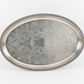 Silver tray with intricate patterns on a white background