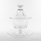 Clear glass dish with lid on a wooden surface attributed to baccarat