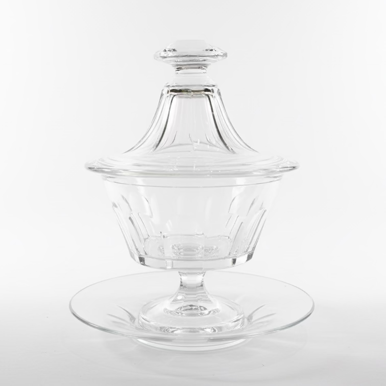 Clear glass dish with lid on a wooden surface attributed to baccarat