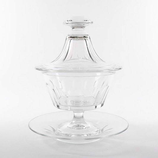Clear glass dish with lid on a wooden surface attributed to baccarat