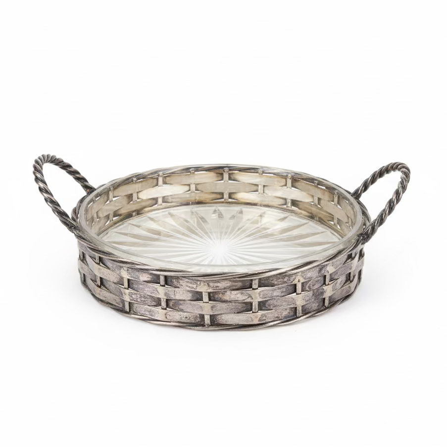 Decorative glass tray on a black surface with a blurred background